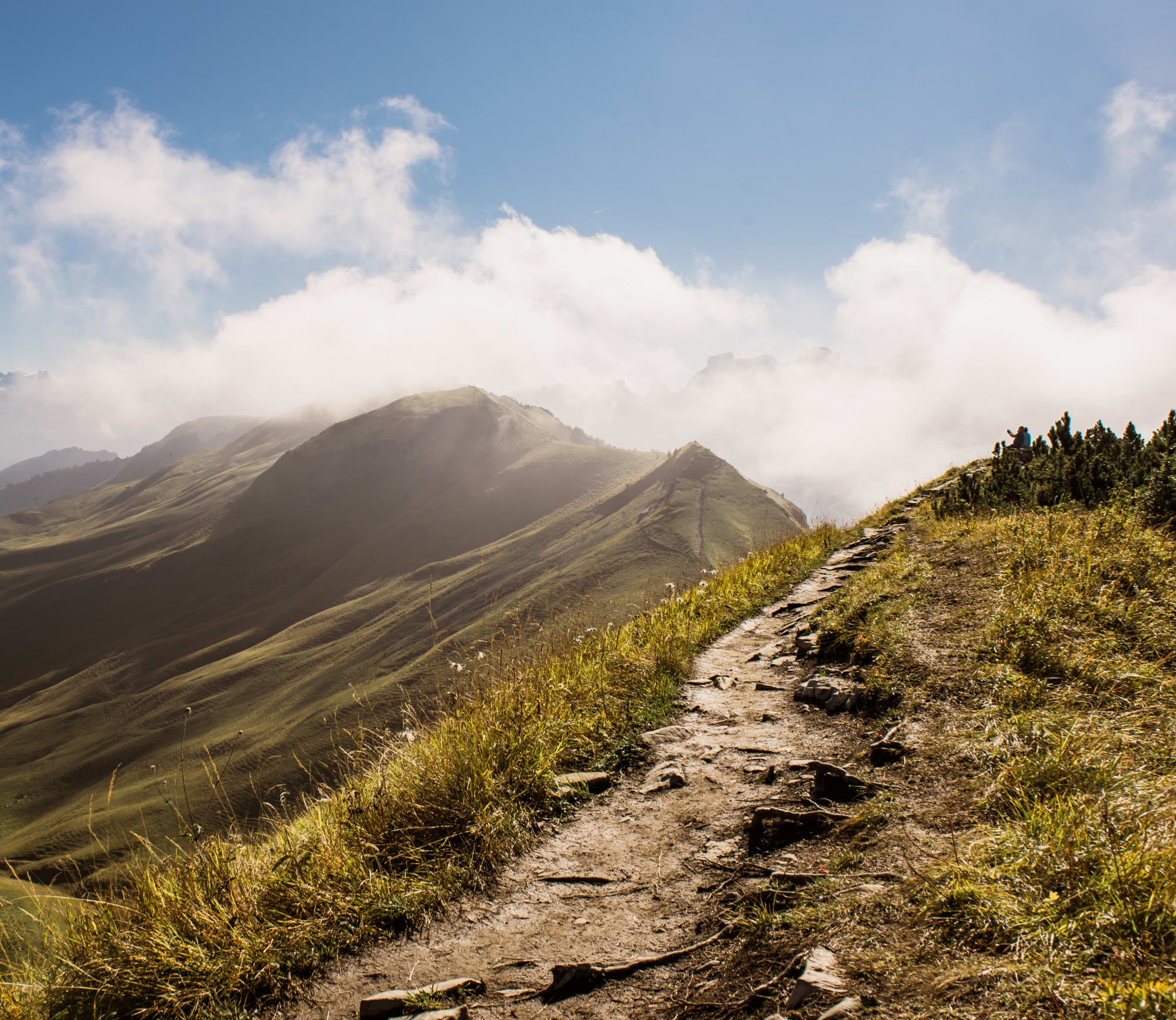 Sentier de randonnée avec vue sur le mont Stoos en arrière-plan, dans une ambiance automnale avec du brouillard.