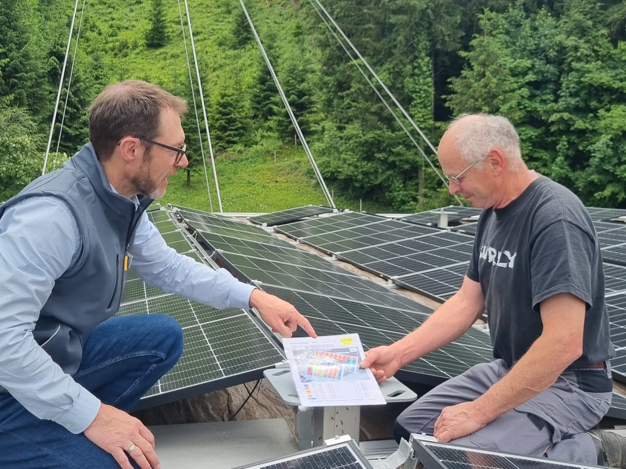 Peter Bircher und Arnold Mathis bei der neuen Photovoltaik Anlage auf dem Dach der Talstation der CabiO Luftseilbahn