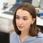 Headshot of Louise Moneyron working at a computer in an office
