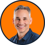 Headshot of Mark O'Donnell smiling against an orange background