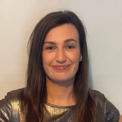 Headshot of Sophie O'Donoghue, smiling, with long dark hair