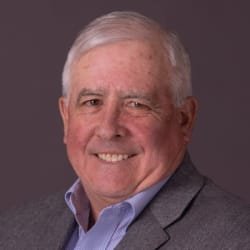 Bill Stratton smiling in a grey jacket, poster for his video testimonial