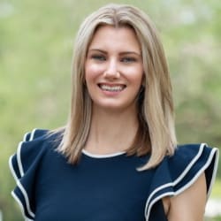Headshot of Kayla Montgomery, smiling, with shoulder-length blonde hair