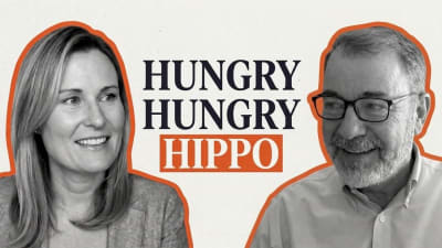 Two smiling people facing each other in a black and white illustration beside the words “Hungry hungry hippo”