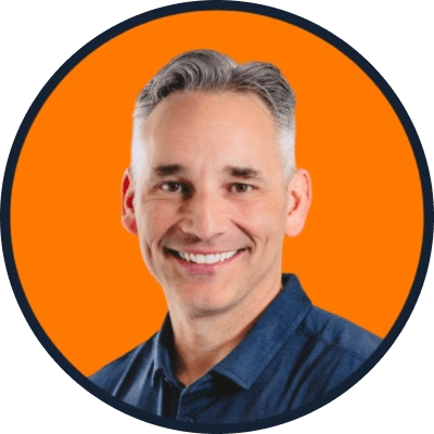Headshot of Mark O'Donnell smiling against an orange background