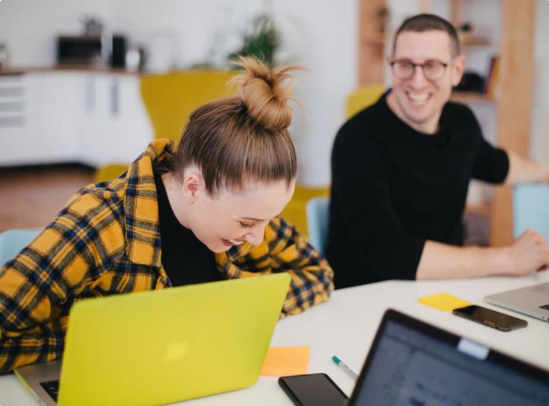 2 worker laughing together