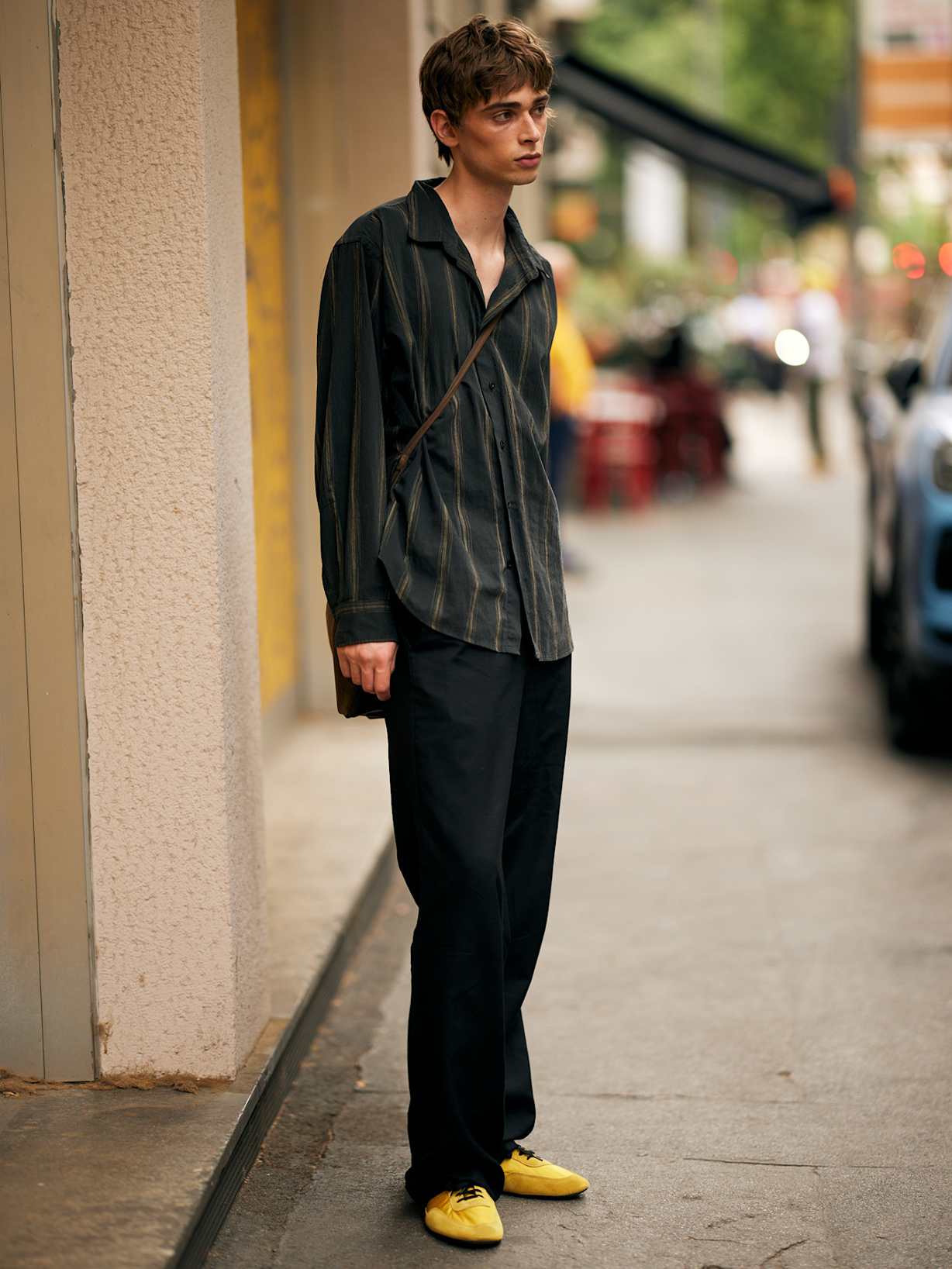 Mann stylt seine senffarbenen Low Profile Sneaker zum einem dunklen Outfit