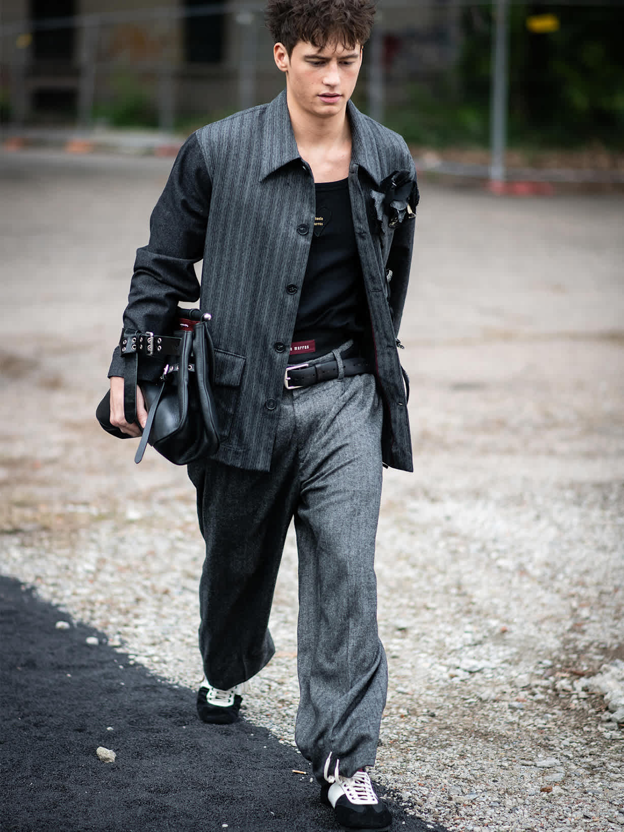 Brünetter Mann trägt T-Toe-Sneaker in Schwarz und Weiß