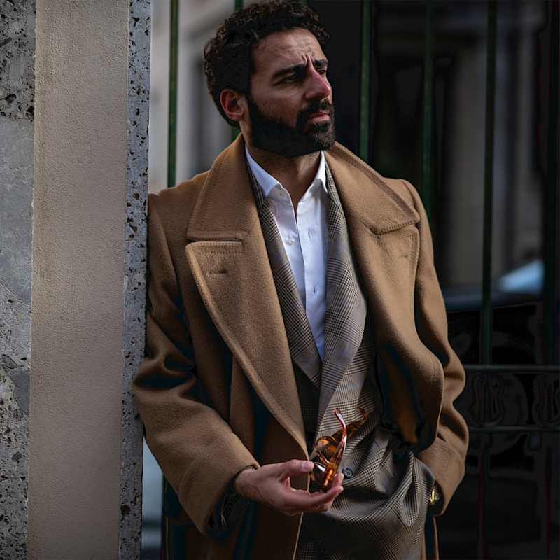 Mann trägt einen Business Casual Look bestehend aus Anzug und Mantel
