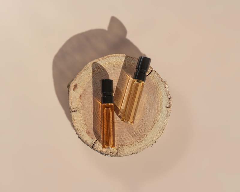 Zwei Duftflakons auf einer Holzscheibe