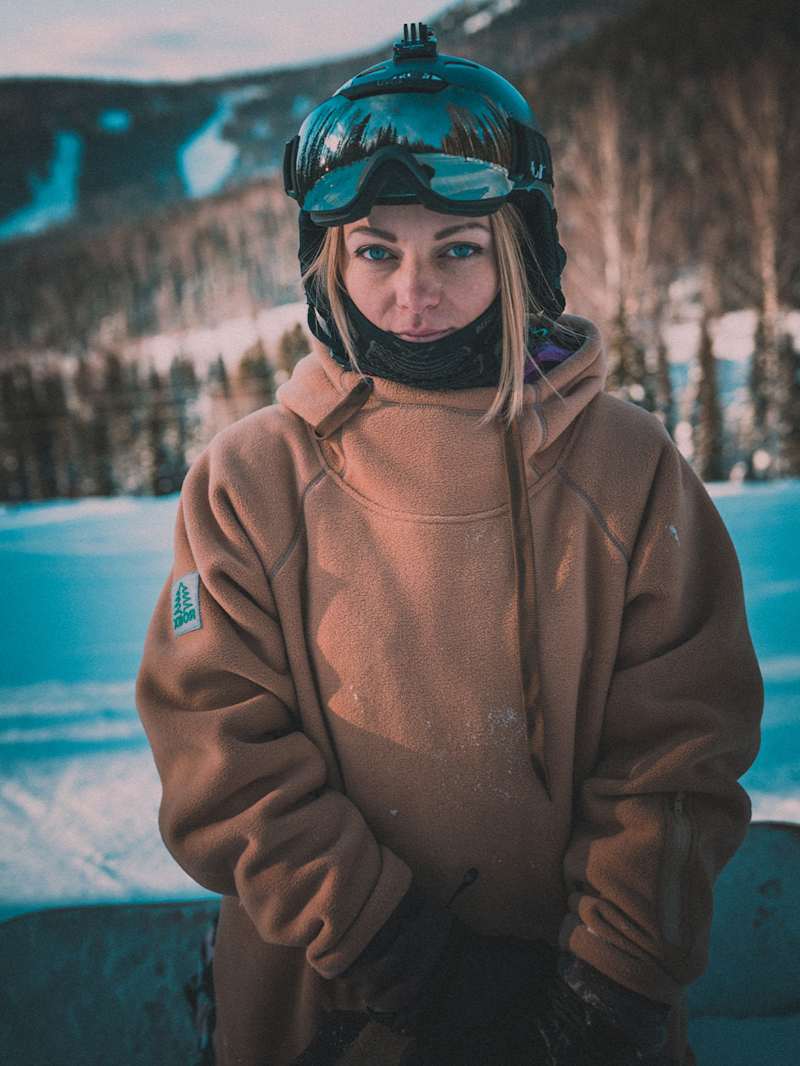 Kobieta w kurtce narciarskiej, kasku i goglach