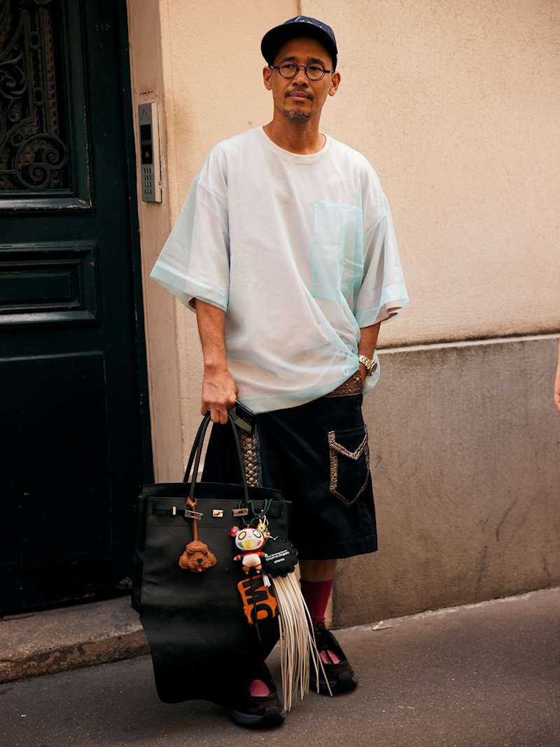 Mann hält einen großen Shopper in der Hand mit Bag Charms