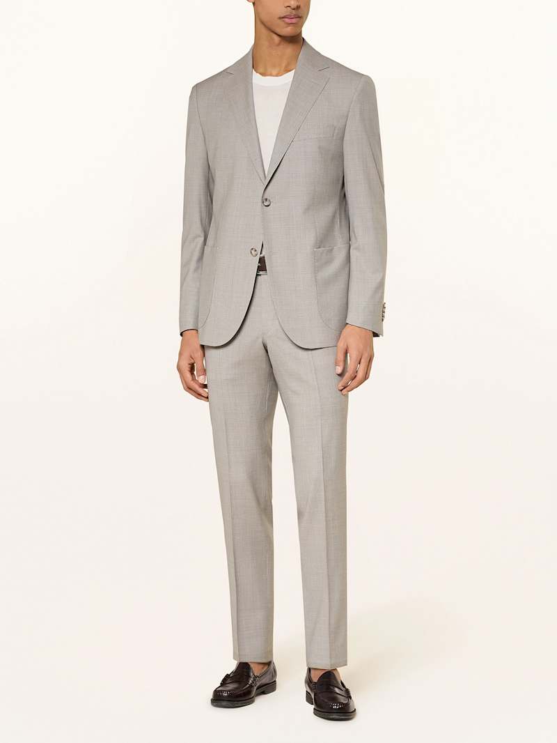 Mann im beigen Anzug mit weißem T-Shirt