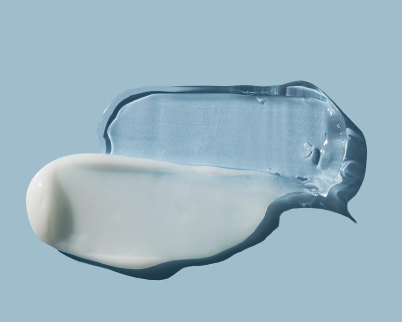 Hyaluron als Creme und Gel auf einem blauen Untergrund