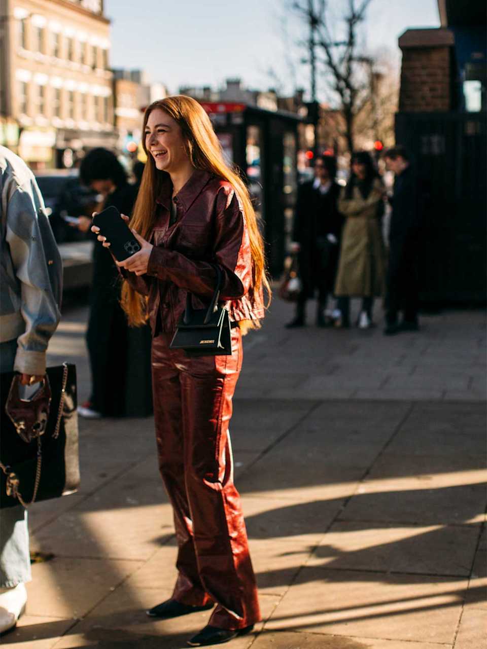 Frau trägt ein Leder-Outfit mit einer roten Lederhose und passender Jacke