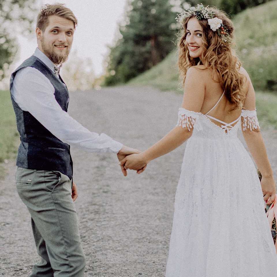 Brautpaar trägt Hochzeits-Outfit für eine Sommerhochzeit