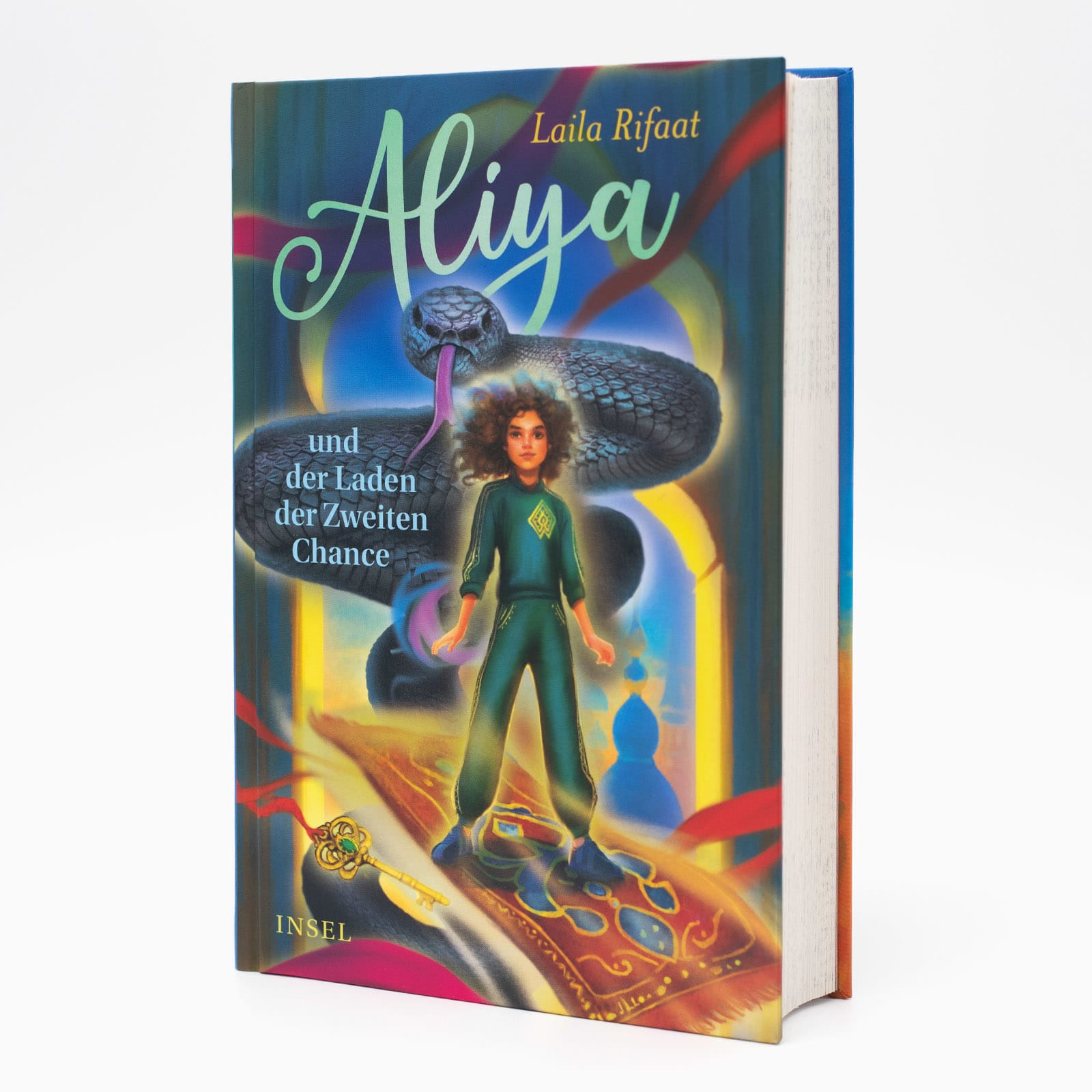 Das Buch »Aliya und der Laden der Zweiten Chance« von Laila Rifaat in Frontansicht. Ein Mädchen steht vor einer schwarzen Schlange auf einem fliegenden Teppich