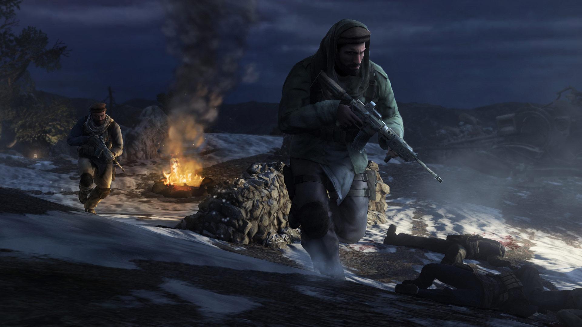 Armed fighters move through a snowy mountain camp at night in Medal of Honor (2010).
