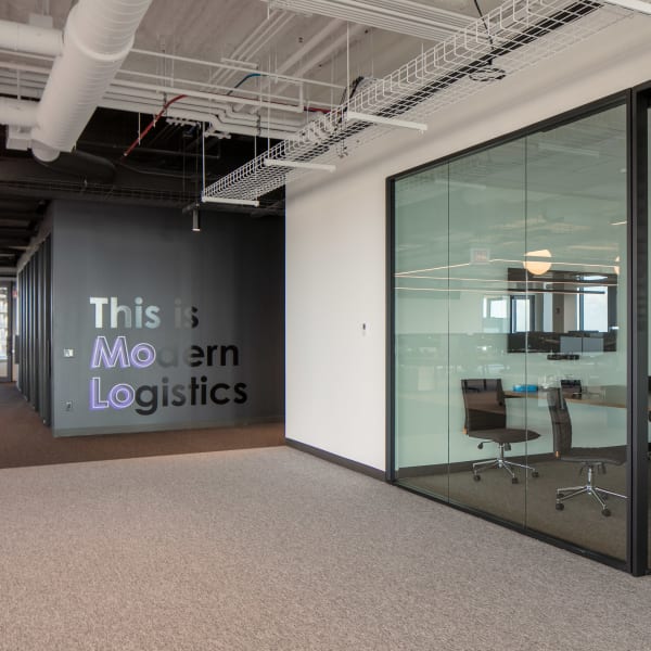 Conference room with window graphics showing room name and dimensional wall graphics beyond.