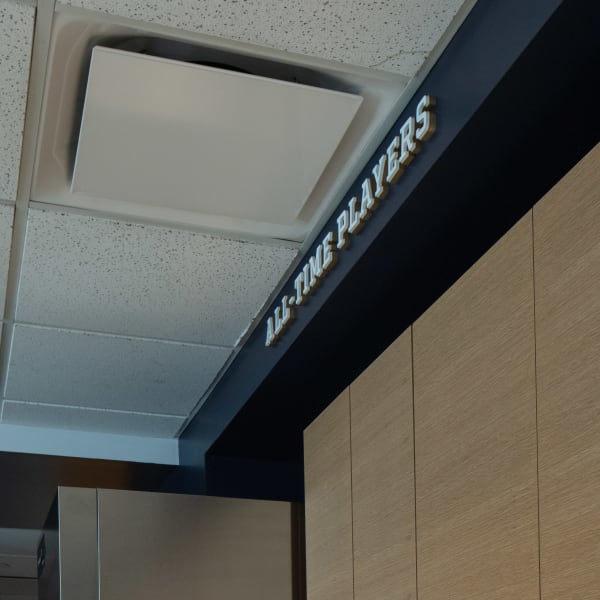 Dimensional lettering detail showing raised gold letters reading 'All-Time Players' on black beam with colored edge.