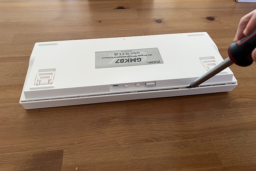 opening the case keyboard with a flat-head screwdriver