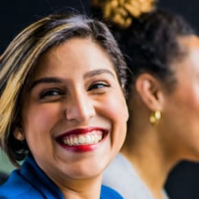 Smiling woman in front of a laptop at work