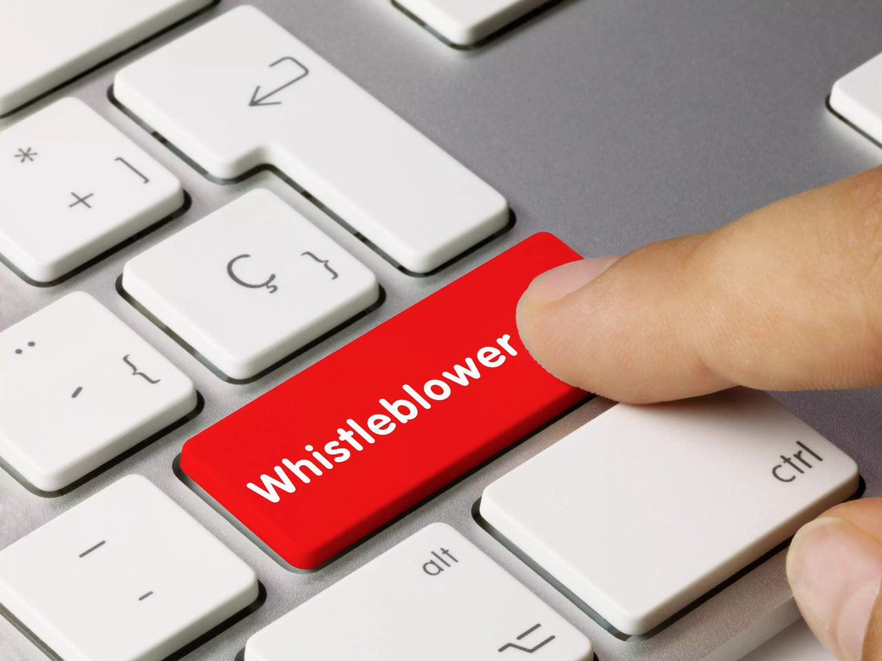 Finger drückt rote Taste „Whistleblower“ auf Tastatur.