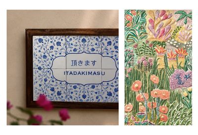 A two-panel image collage featuring unique painted artworks: the left panel shows a wooden-framed, hand-painted ceramic tile piece by Pune-based artist Shibani, featuring cobalt blue botanical patterns and the Japanese word "ITADAKIMASU" (頂きます); the right panel shows a vibrant, heavily textured botanical painting by Bengaluru-based artist Aanchal, filled with pastel pink, orange, and green sculpted floral motifs.