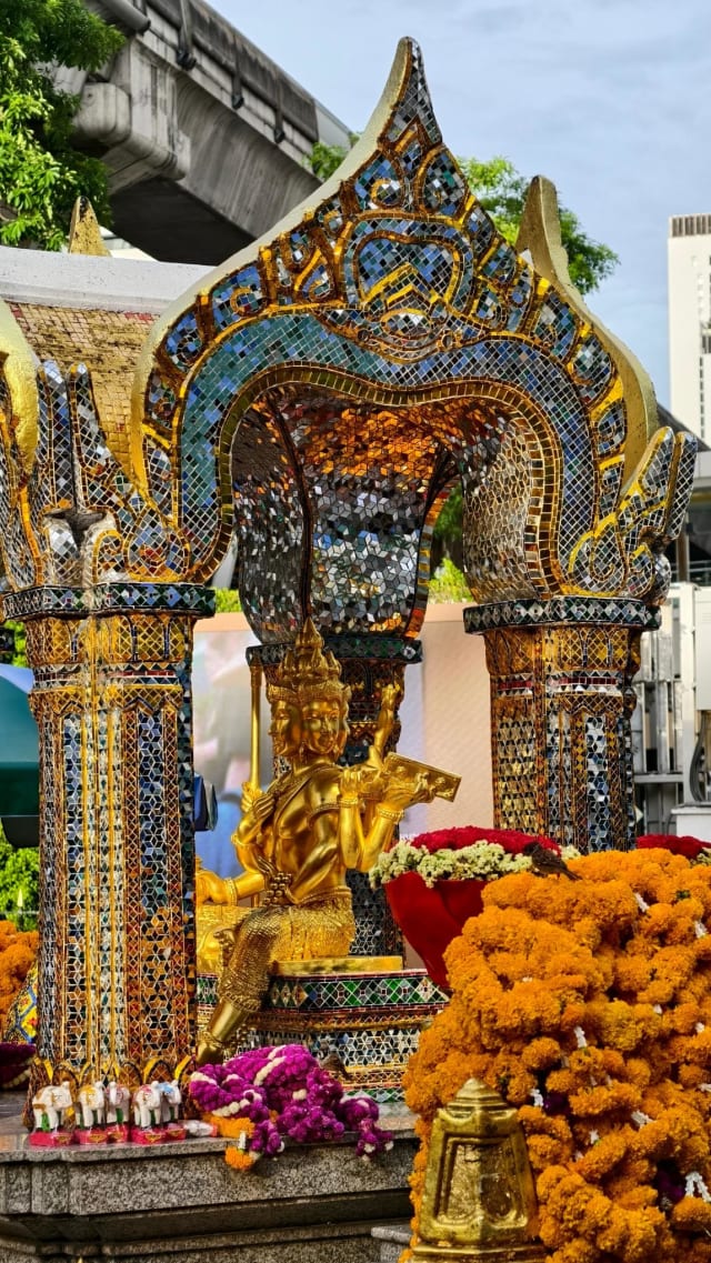 The shrine pavilion with marigold garlands and carved elephant offerings placed around its base