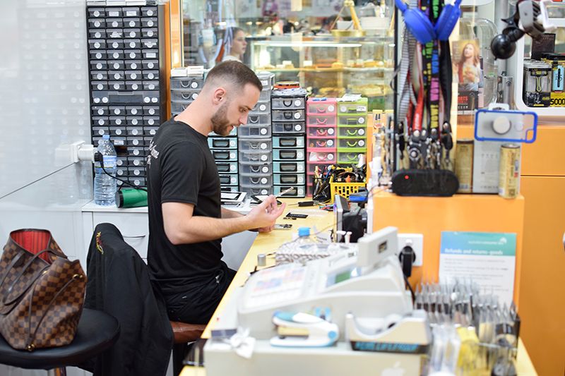 Mobile phone technician repairing a phone