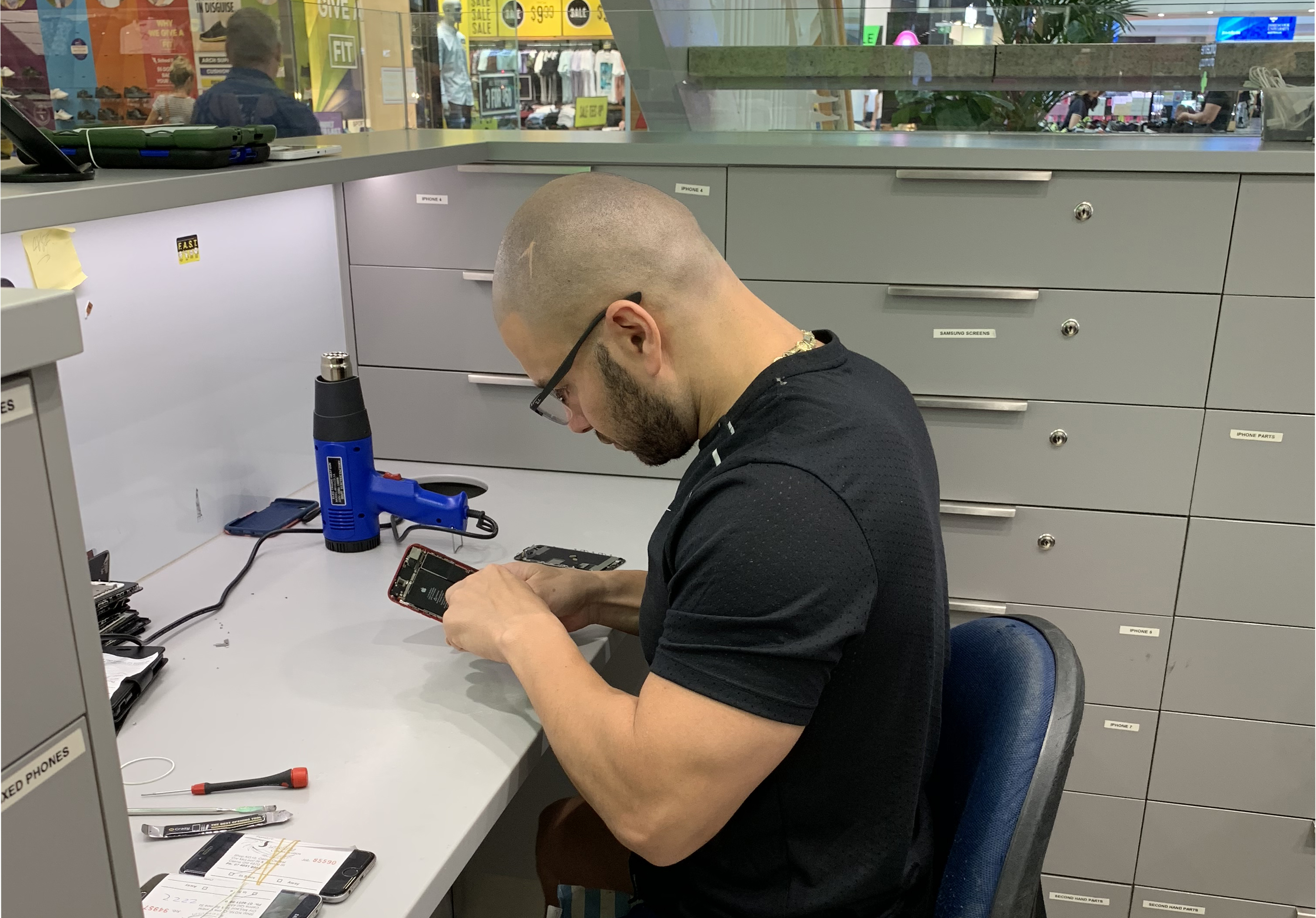 Mobile phone repair technician working