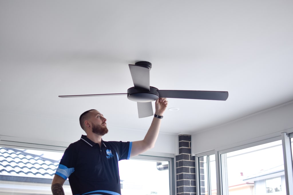 Electrician Installing Outdoor Fan