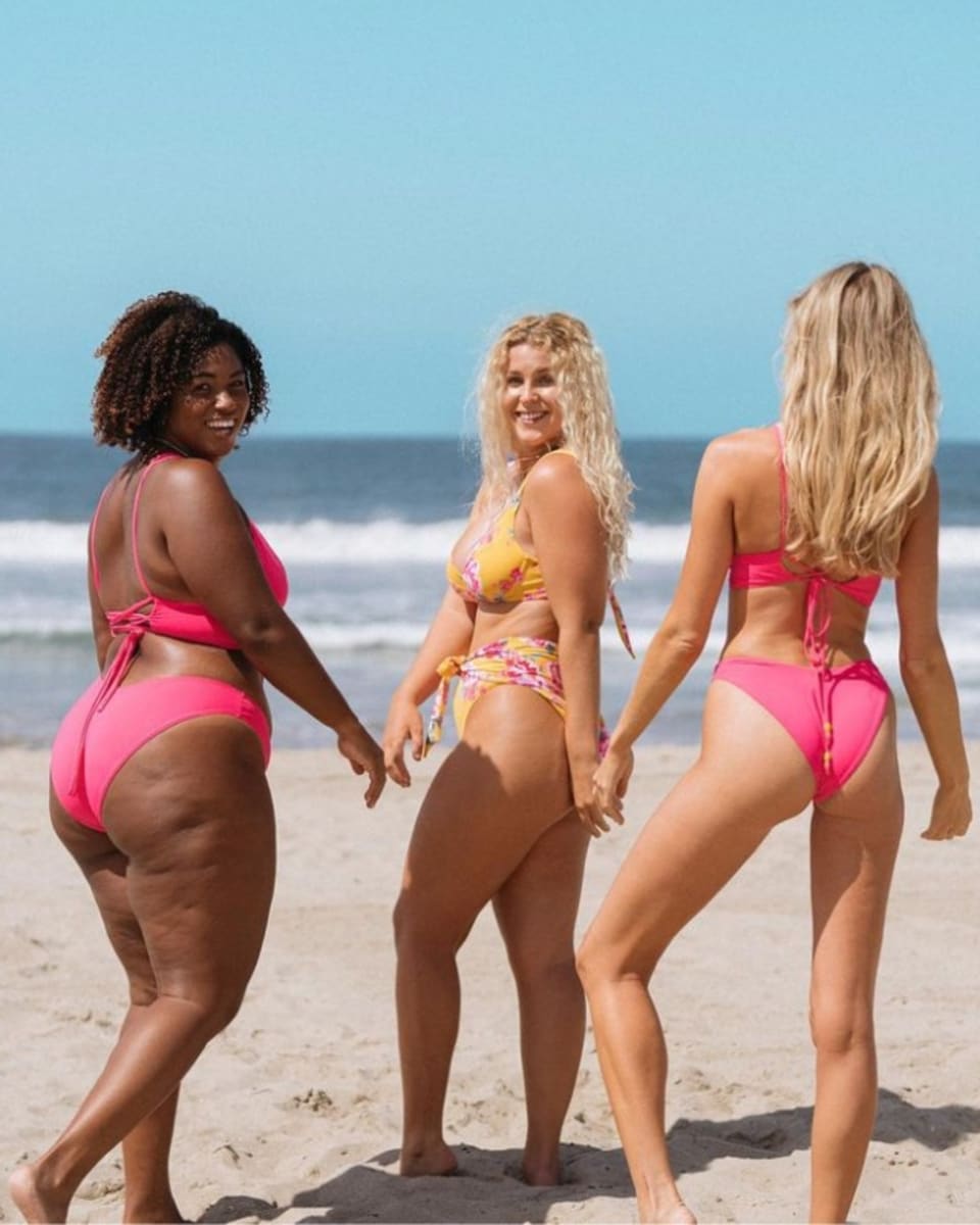 Three women wearing Maaji bikinis on the beach