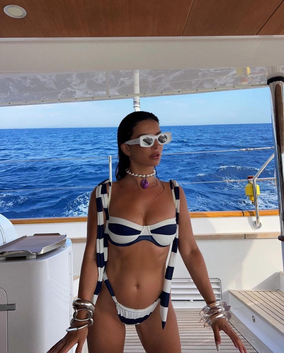 Aureta wearing a striped bikini