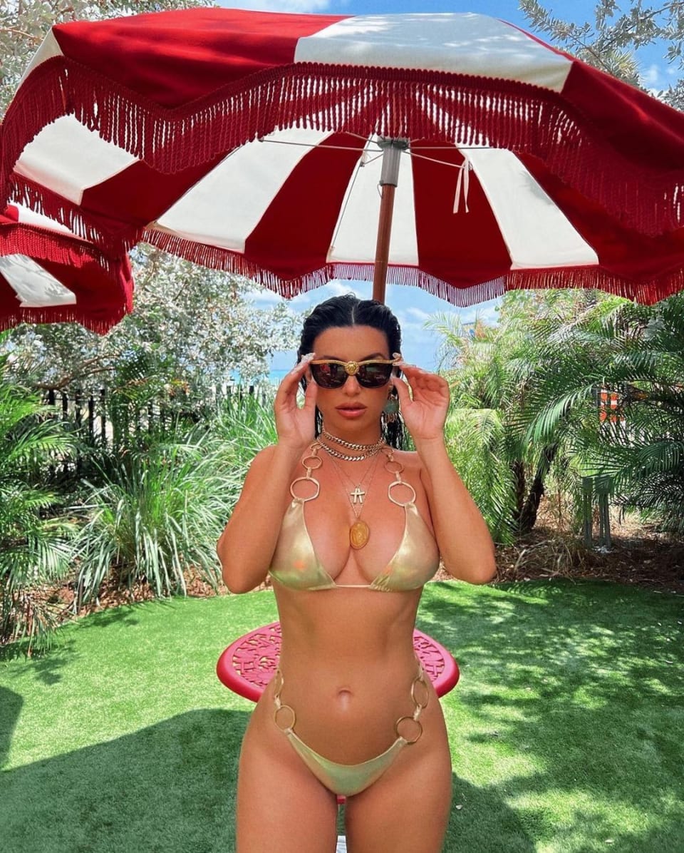 Aureta wearing a ring gold bikini