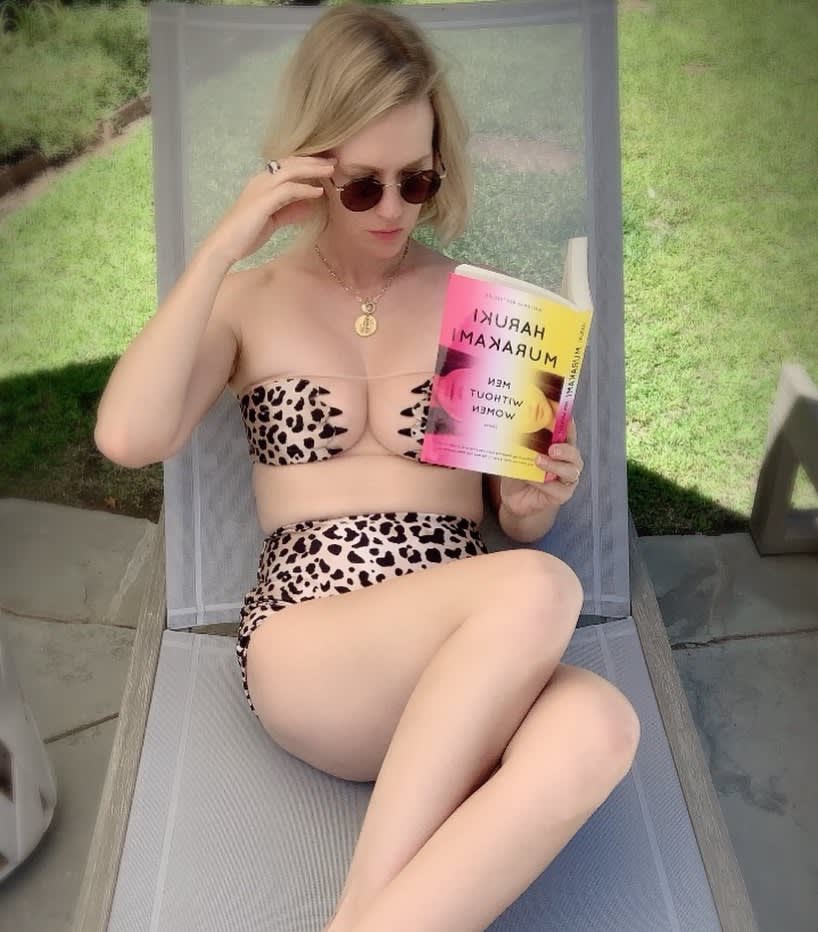 Photo fo January Jones reading a book with leopard bikini by Adriana Degreas