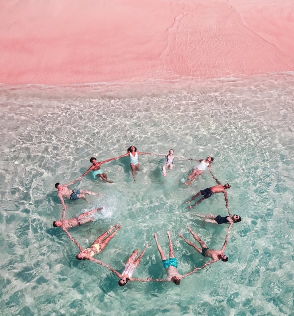 Photo of a group of people making a circle in the water