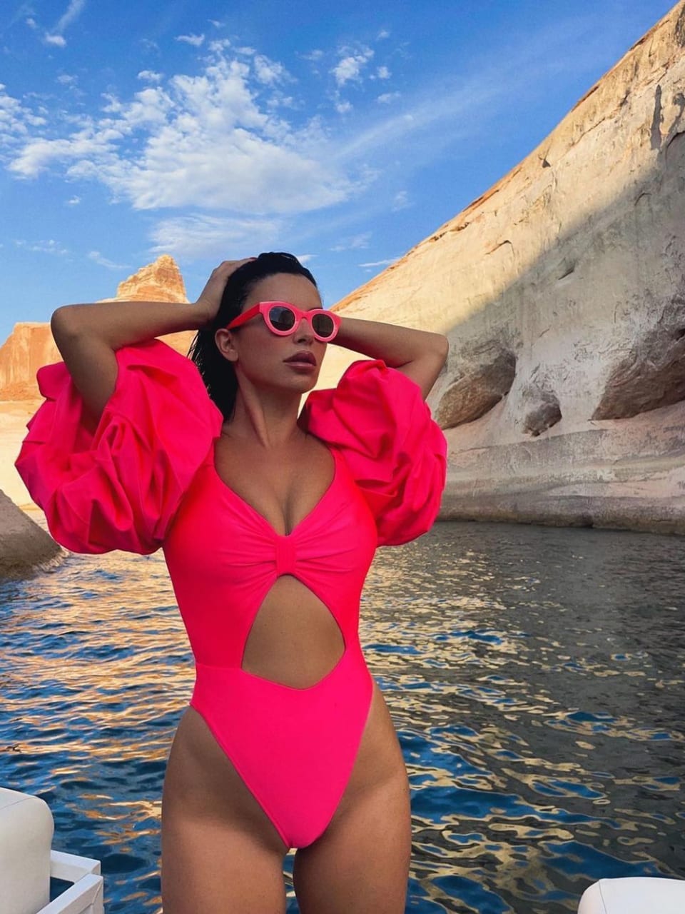 Aureta wearing a neon purple swimsuit