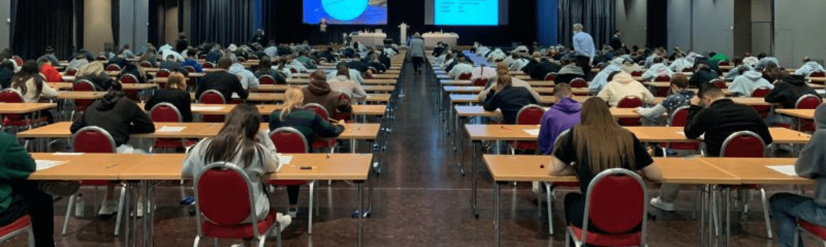 Exam hall full of students writing the Cambridge exam with Swiss Exams
