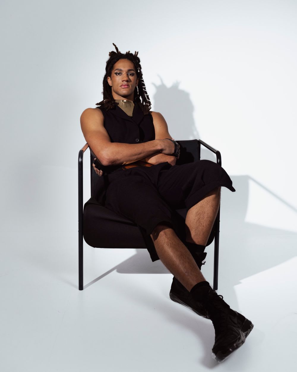 Fashion model photographed against a bright studio backdrop