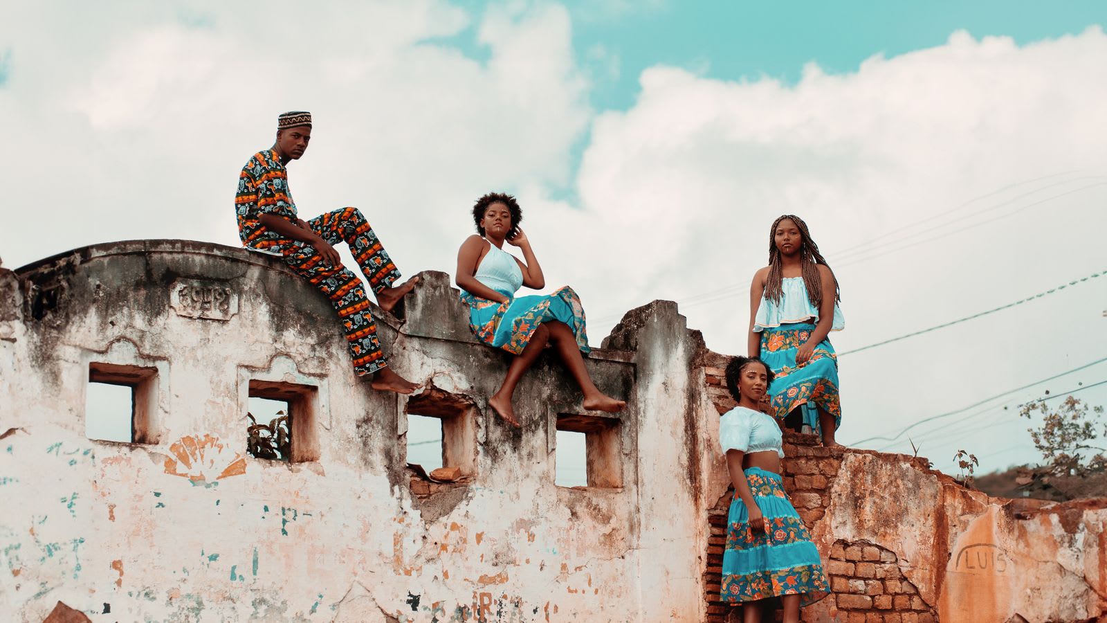 Four models in vibrant traditional dress photographed together