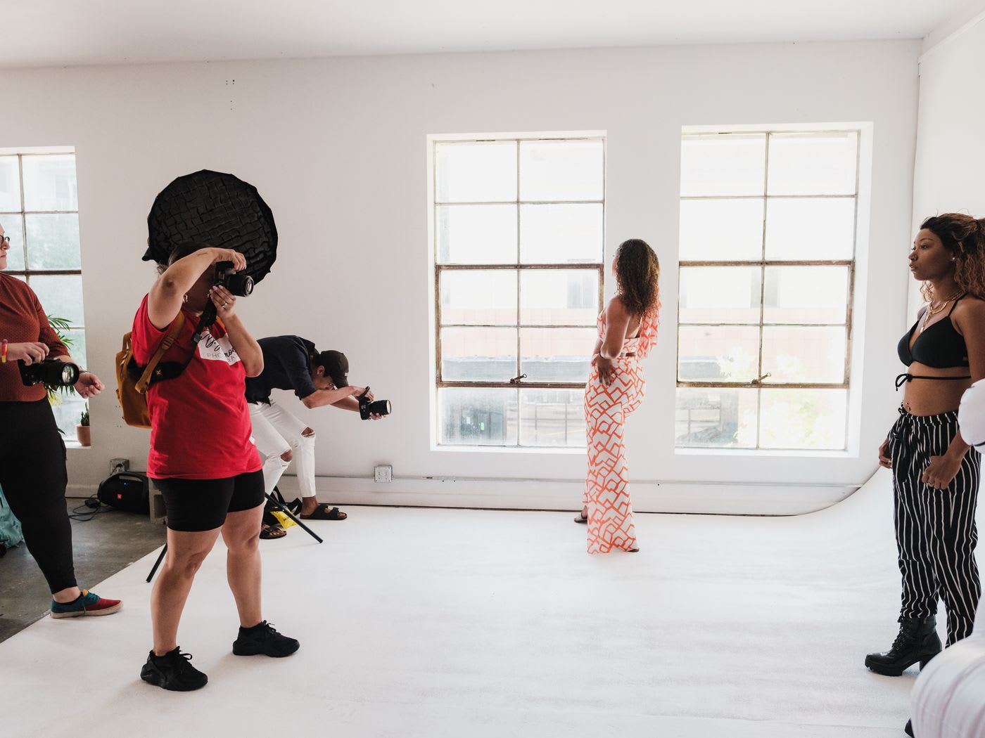 A group session in a studio with photographers and models