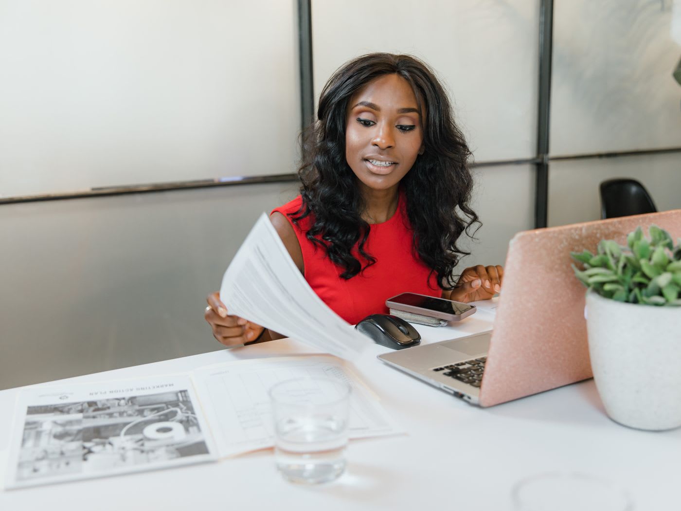 Reviewing documents and a laptop in an office