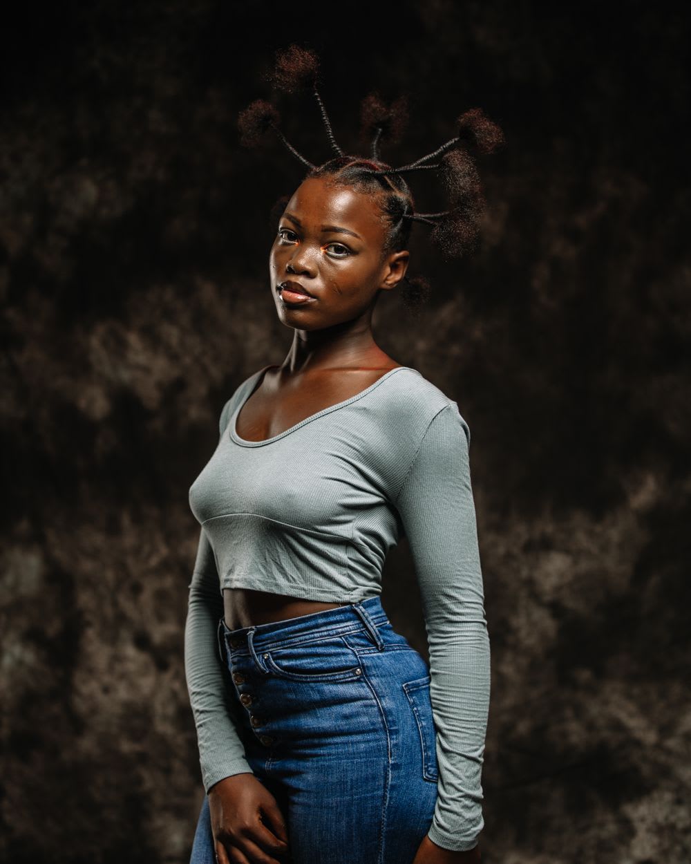 Amara Osei, photographed in a studio against a dark backdrop