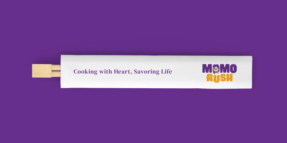 A white chopstick sleeve carrying the two-colour MomoRush logo, laid on a purple ground