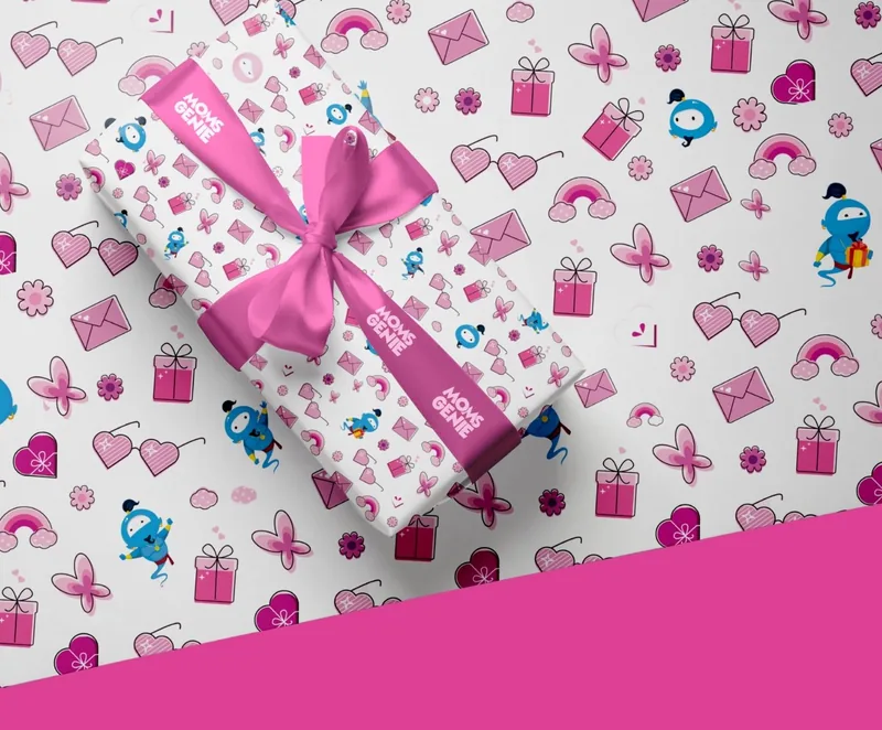 MomsGenie gift-wrap pattern: Wishie among presents, hearts, envelopes and rainbows around a wrapped gift
