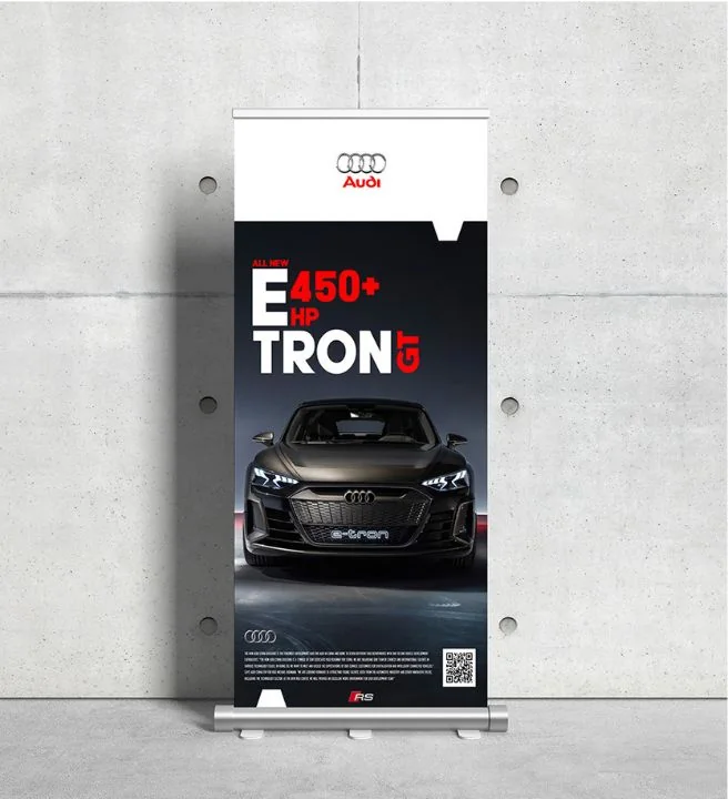 A dark roll-up standee for the Audi e-tron GT, the car head-on beneath the lettering