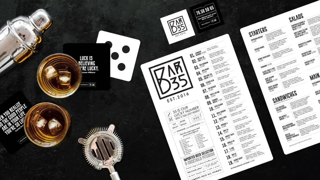 Bar 35 menus and coasters on a dark bar top, the boxed logo on the menu and a coaster