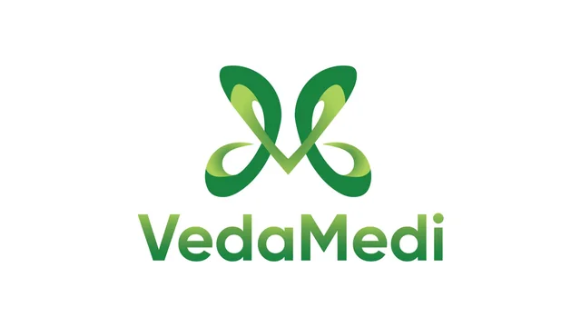 The VedaMedi logo: a green symbol merging a V and an M above the VedaMedi wordmark
