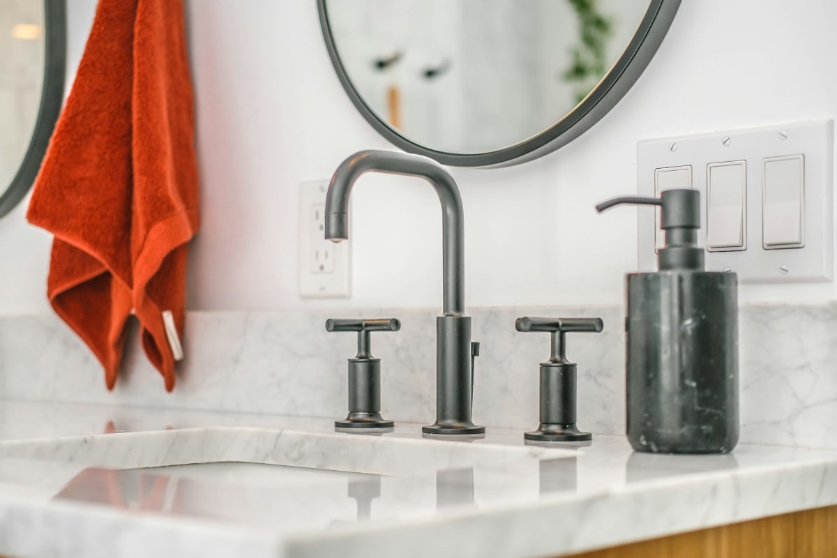 Matte black faucet on a marble vanity